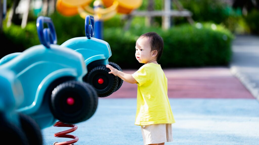 Portrait of Happy child playing with toys and enjoying the playground in the park, Sensory learning.